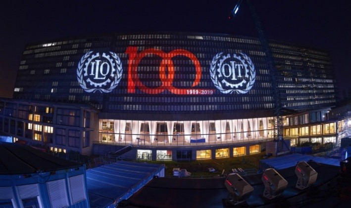 Proyección sobre la sede del la OIT de la identidad visual con la que el organismo internacional celebra su centenario