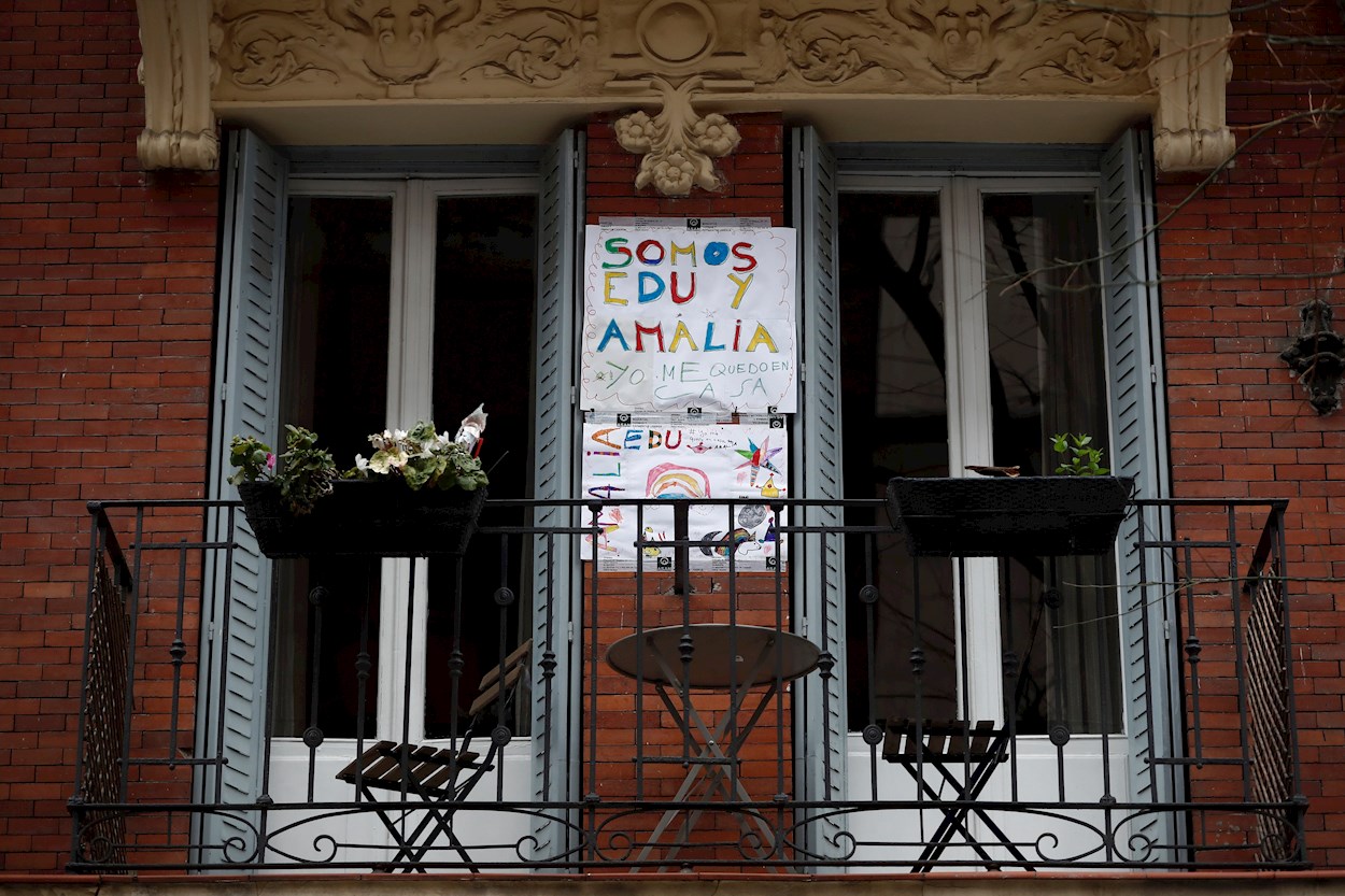 Un cartel realizado por niños que invita a quedarse en casa cuelga de la pared del balcón de una vivienda de Madrid. EFE/Mariscal