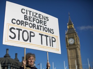 A woman demonstrates in central London on October 11, 2014, against the proposed Transatlantic Trade and Investment Partnership (TTIP). Brussels released the playbook for its talks with Washington on a giant EU-US trade deal on Thursday, saying it wanted to be transparent about a pact that has been criticised for favouring big business.  AFP PHOTO / JUSTIN TALLIS        (Photo credit should read JUSTIN TALLIS/AFP/Getty Images)
